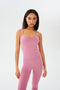 The model is wearing a pink SPLITS59 Airweight Tank - Rosewood and leggings.
