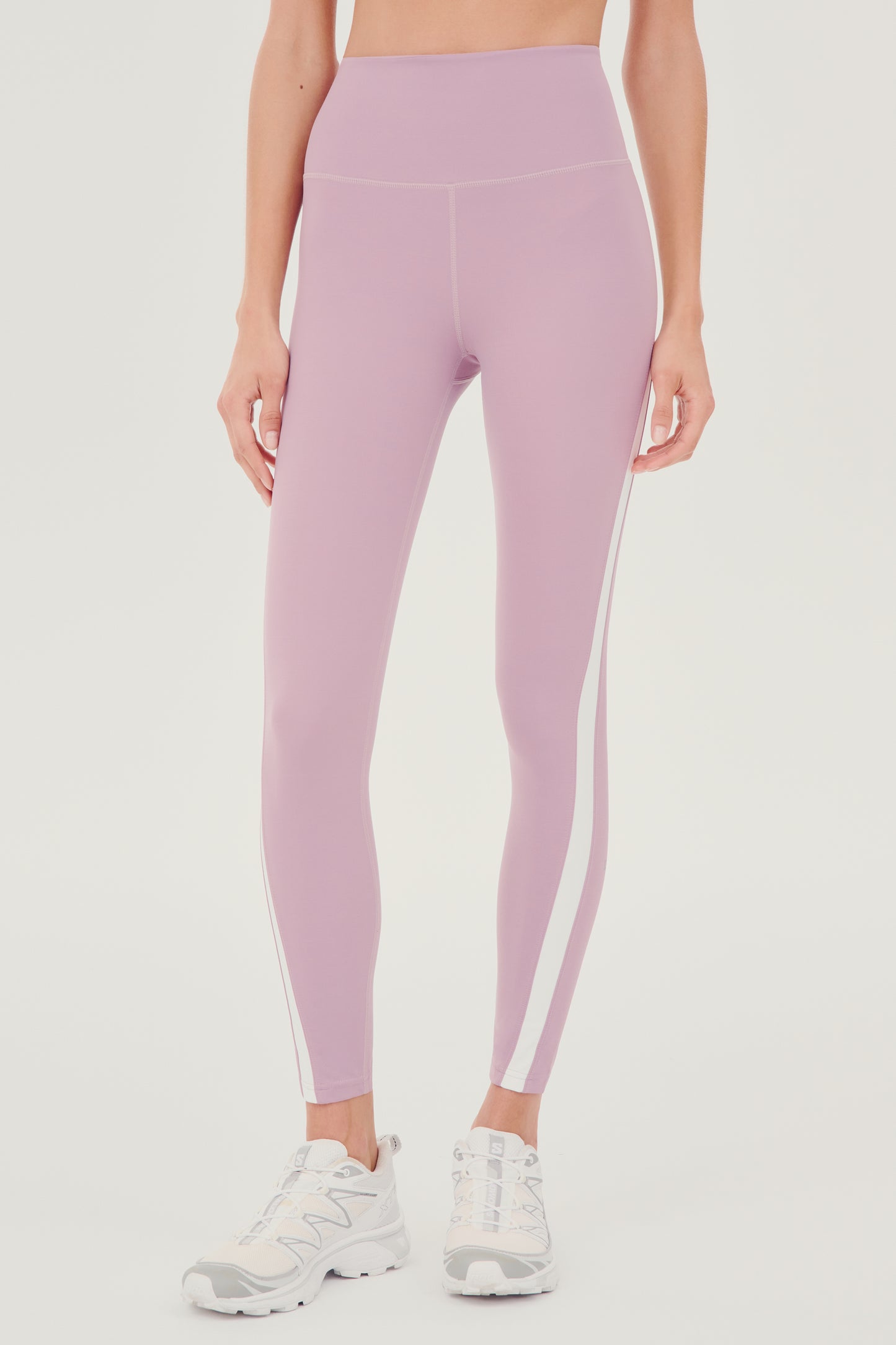 A woman's Miles High Waist Rigor 7/8 leggings in Blush and White, perfect for yoga by SPLITS59.