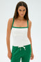 A person wearing the Monah Rigor Tank in White/Arugula by SPLITS59 and green spandex pants, stands against a plain background.