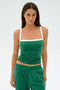 A person wears the Monah Rigor Tank by SPLITS59—a green sleeveless top with white straps—paired with matching green pants, standing against a plain white background.