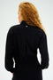 A person with long curly hair is wearing a SPLITS59 Harlowe Rigor Jacket - Black and facing away from the camera.