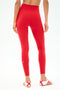 A person wearing SPLITS59 Airweight High Waist Legging in Pirate Red, made from soft Airweight fabric.