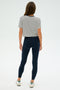 Person in a SPLITS59 Djuna Crop Ringer - Indigo Stripe, black leggings, and white sneakers stands with their back to the camera against a plain background, ready for a gym workout or CrossFit training.