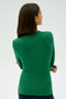 A person with long dark hair is wearing the Louise Rib Long Sleeve in Arugula by SPLITS59, featuring a blend of modal and spandex, viewed from behind against a plain backdrop.