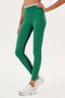 A woman wearing SPLITS59's Easton Rigor High Waist 7/8 in Arugula/White, ready for her yoga session.