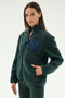 A woman wears the SPLITS59 Harris Sherpa Jacket in Military/Indigo, featuring a zippered navy chest pocket, along with matching pants, standing against a plain light background.