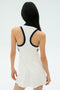 A person with long dark hair, seen from behind, is wearing the SPLITS59 Austin Rigor Dress in White/Indigo with a racerback design.