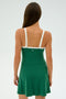 A person with long hair is viewed from the back wearing a Monah Rigor Dress - Arugula/White by SPLITS59 against a plain light background.