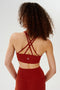 Back view of girl wearing red 4 criss crossed spaghetti straps sports bra