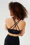 Back view of girl wearing black 4 criss crossed spaghetti straps sports bra
