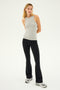 A woman wearing the SPLITS59 Kiki Rib Tank Full Length in Heather Grey, paired with black flared pants and grey sneakers, stands against a plain background.
