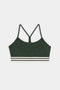 The SPLITS59 Cali Active Rib Bra is a dark green sports bra with thin straps, a racerback design, and white and black striped bands at the bottom.