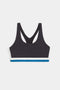 The SPLITS59 Maci Airweight Bra in Graphite/White is a black racerback sports bra with white and blue bands at the bottom hem, shown on a white background.