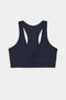 The SPLITS59 Indigo Airweight Bra with Ruching features a ruched front detail and a racerback design on a white background.