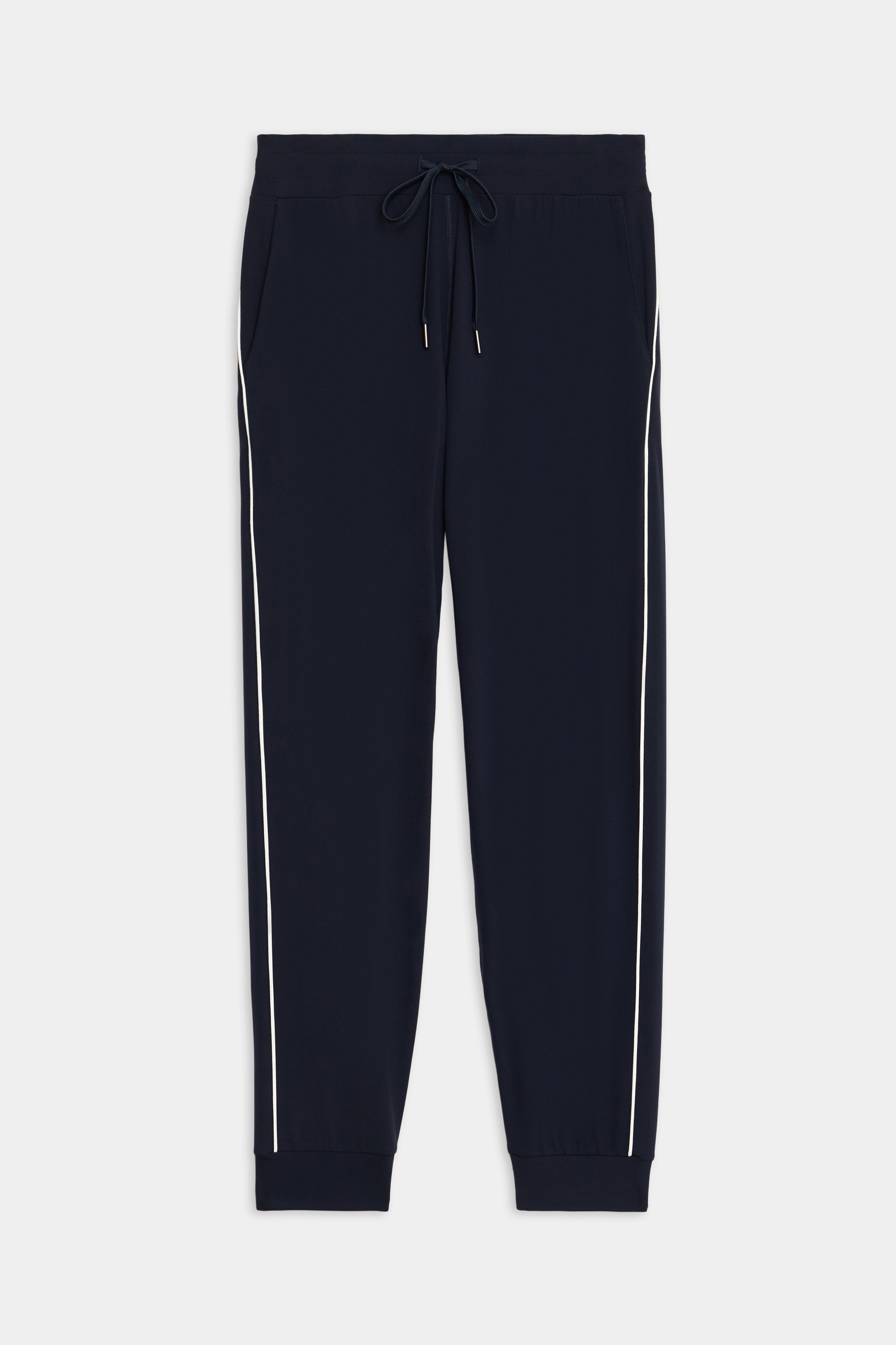 SPLITS59 Airweight Jogger 7/8 with Piping in navy blue, featuring a drawstring waistband, side pockets, white side piping, and cuffed ankles, shown laid flat on a white background.