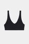 The SPLITS59 Airweight Scoop Back Bra is a black, wireless bralette with wide straps, a scoop back, and seamless construction, shown on a plain white background.