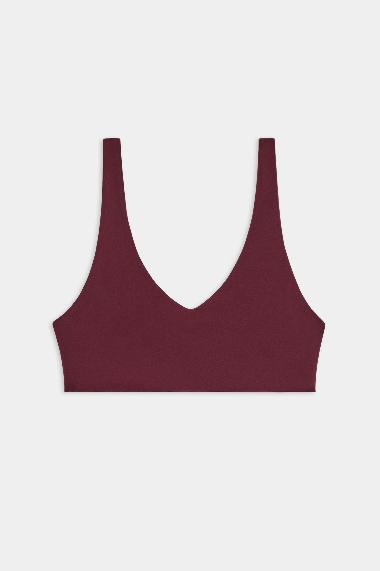The SPLITS59 Airweight Scoop Back Bra, shown in burgundy with a deep V-neckline and wide shoulder straps, is displayed against a plain white background.