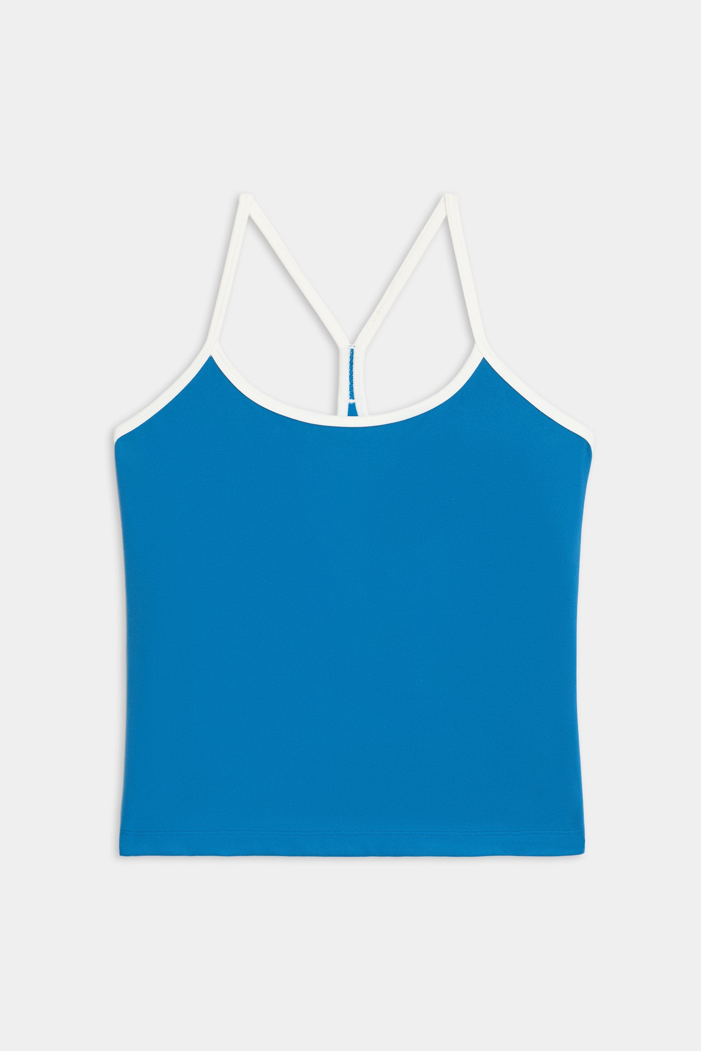 The Airweight Tank by SPLITS59 is a blue camisole top with white spaghetti straps and trim, shown against a plain white background.