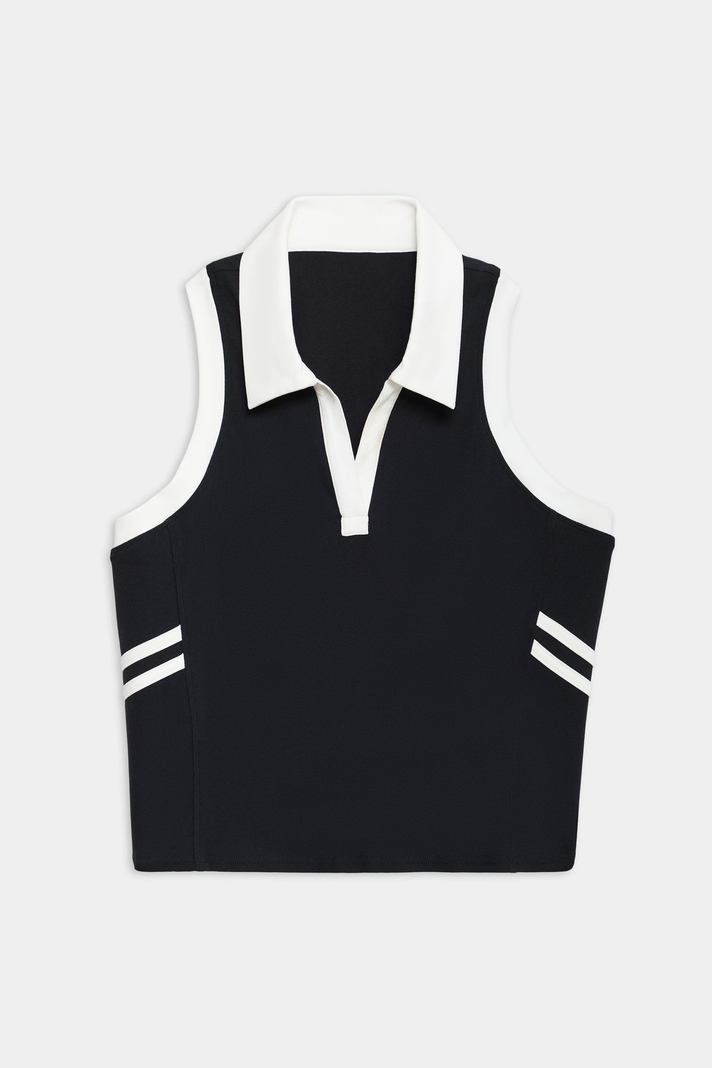 The SPLITS59 Austin Airweight Crop Polo is a sleeveless black top with a white collar, V-neck, and two white stripes near the hem on each side.