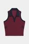 The SPLITS59 Austin Airweight Crop Polo is a sleeveless maroon knit top with a navy collar, trim, and two navy stripes on each armhole.