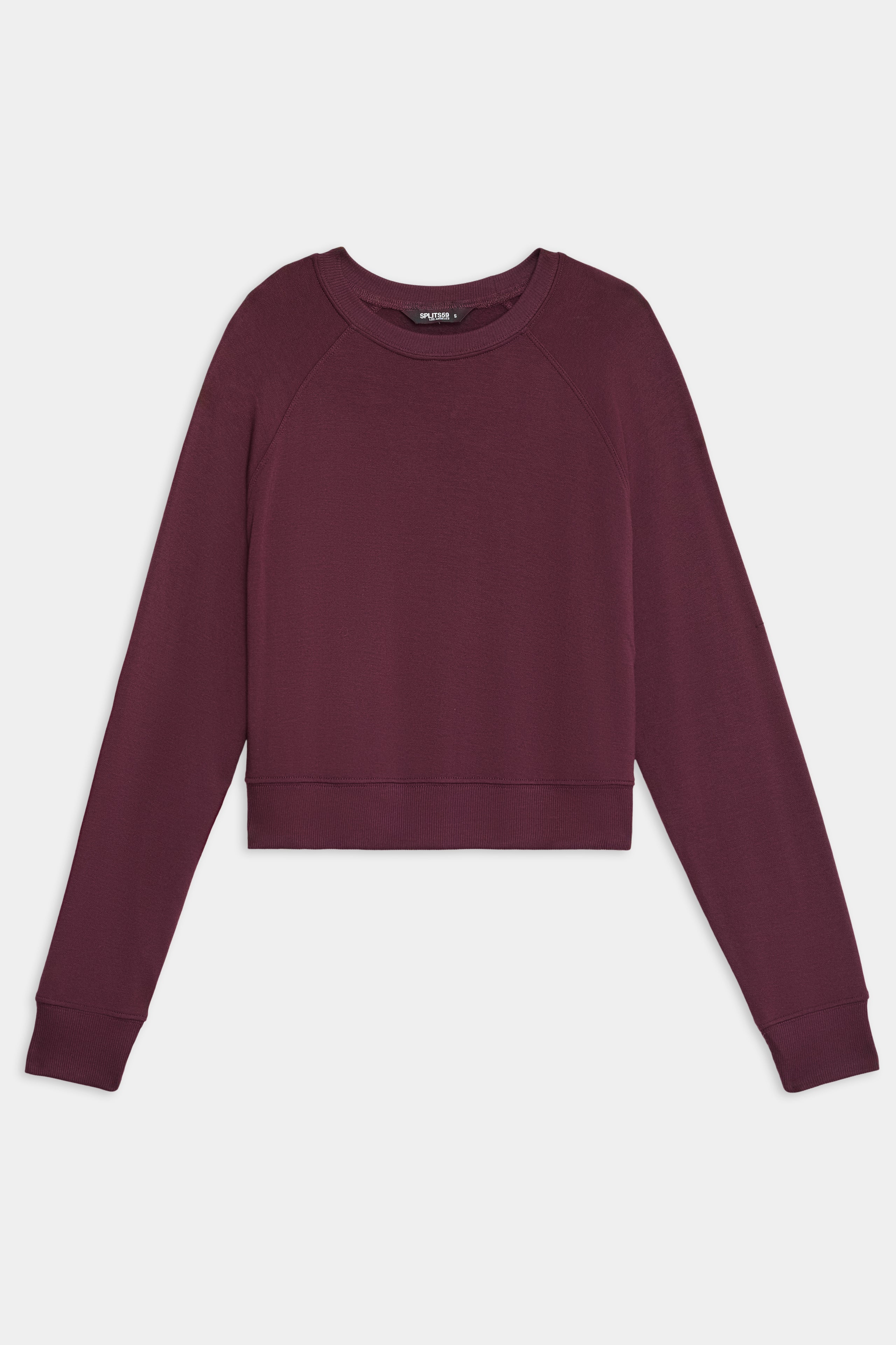 The SPLITS59 Brooks Fleece Long Sleeve Sweatshirt, a maroon crew-neck cropped style, is displayed laid flat against a white background.