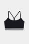 The SPLITS59 Cali Active Rib Bra in black features thin shoulder straps and two white stripes on the elastic band, showcased against a plain white background.