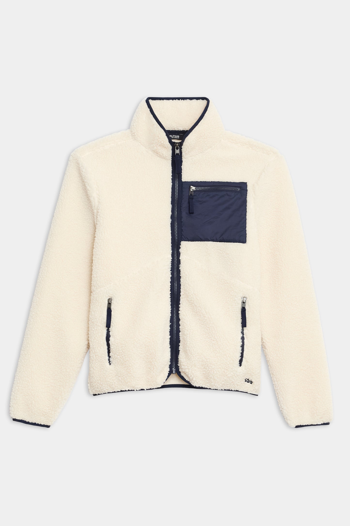 The SPLITS59 Harris Sherpa Jacket is a cream fleece with navy trim, a front zipper, two side zip pockets, and a navy chest pocket.