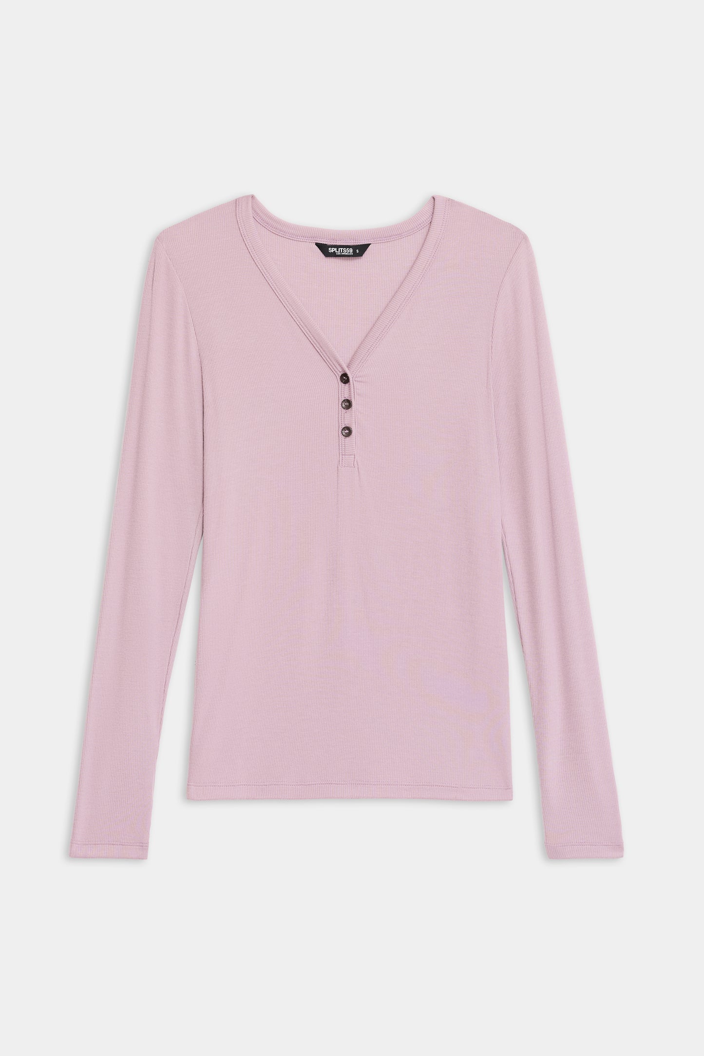 The SPLITS59 Louise Rib Henley is a light pink, long-sleeve shirt with a V-neckline and four front buttons, shown laid flat on a white background.