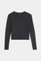 The SPLITS59 Djuna Long Sleeve is a plain black crop top with long sleeves and a crew neckline, shown laid flat on a white background.