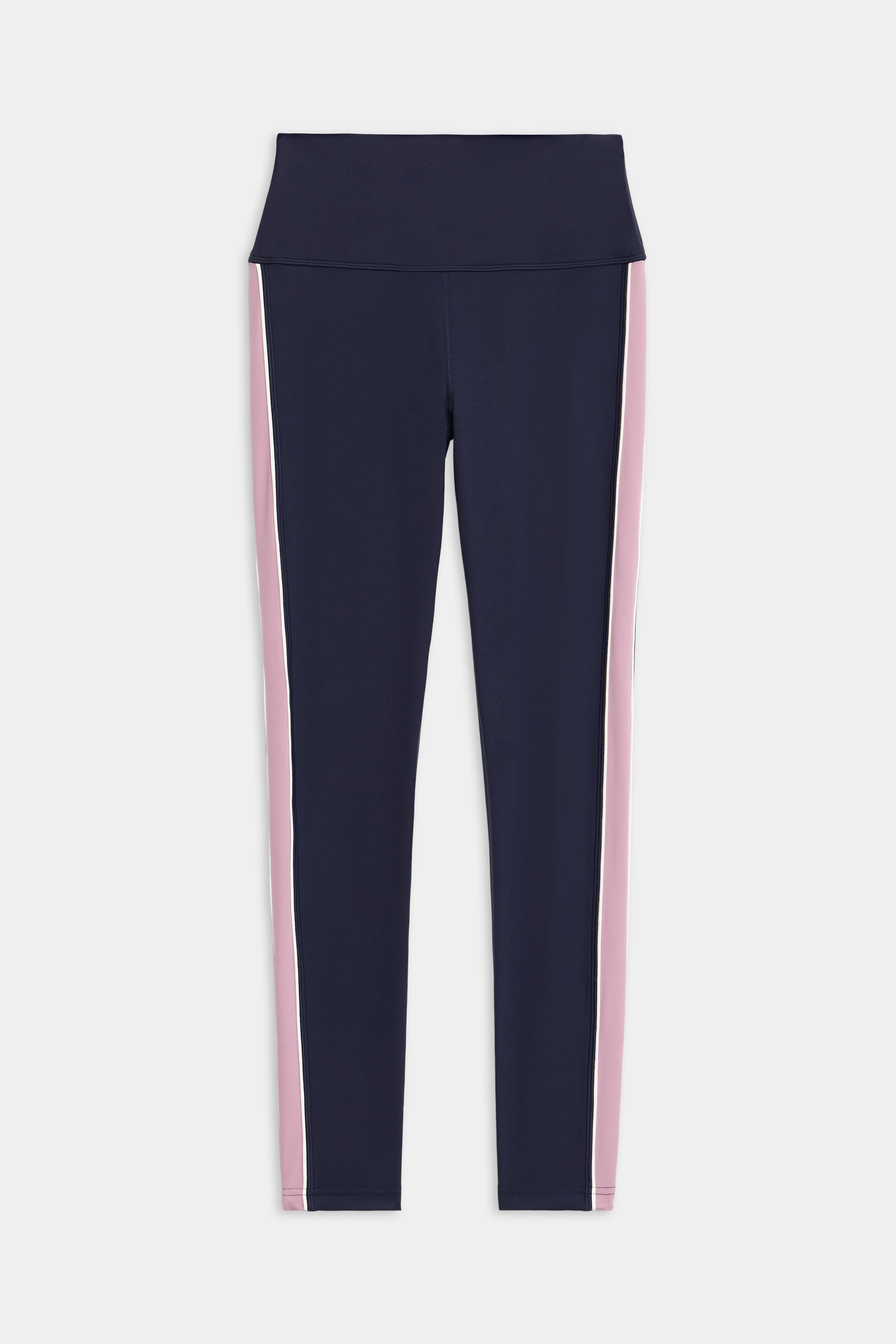 The Margot Rigor Legging by SPLITS59 features a navy blue design with a wide waistband and vertical pink and white stripes along the sides.