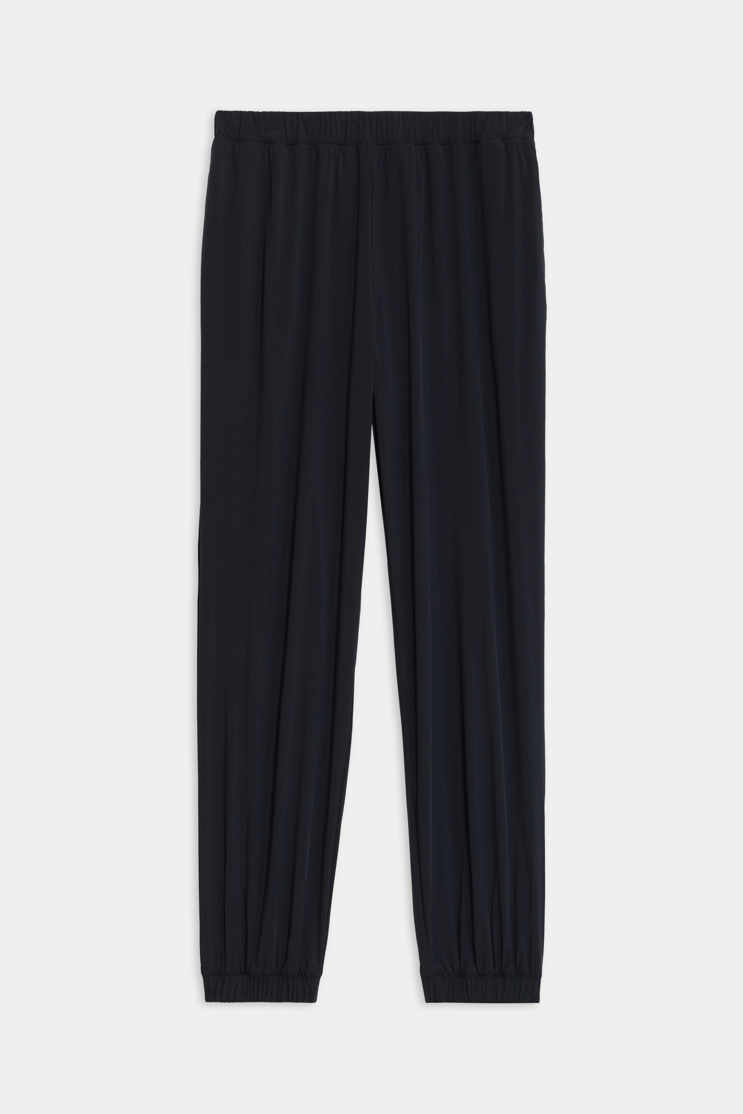 The Megan Woven Nylon Jogger from SPLITS59 features black with an elastic waistband and gathered cuffs, showcased on a plain white background.