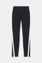 The Miles High Waist Rigor 7/8 leggings from SPLITS59 feature contrasting color stripes on the sides, set against a chic black and white background.
