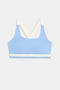 The Miles Rigor Bra by SPLITS59 is light blue with white straps and trim, featuring a racerback design.