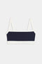 The SPLITS59 Monah Rigor Bra is a navy blue and white color block bralette with thin white straps, shown laid flat on a plain background.