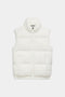 The SPLITS59 Summit Nylon Puffer Vest in white features a sleeveless design, high collar, front zipper closure, and two side pockets for lightweight insulation—ideal for cool weather workouts. Shown laid flat on a white background.