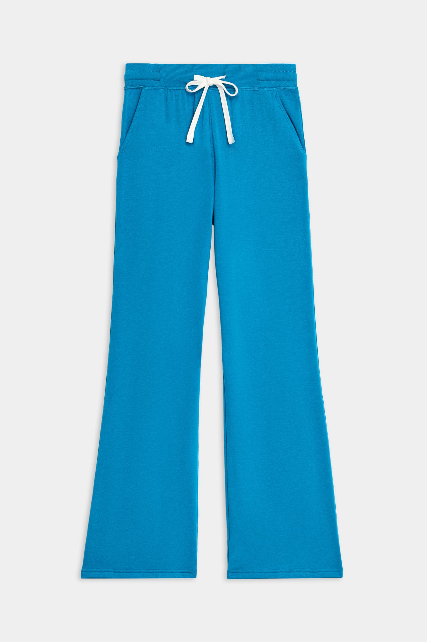 The SPLITS59 Raven Fleece Full Length Sweatpant in Stone Blue features a relaxed fit, ultra-luxe fleece fabric, white drawstring waist, and side pockets, shown laid flat on a white background.