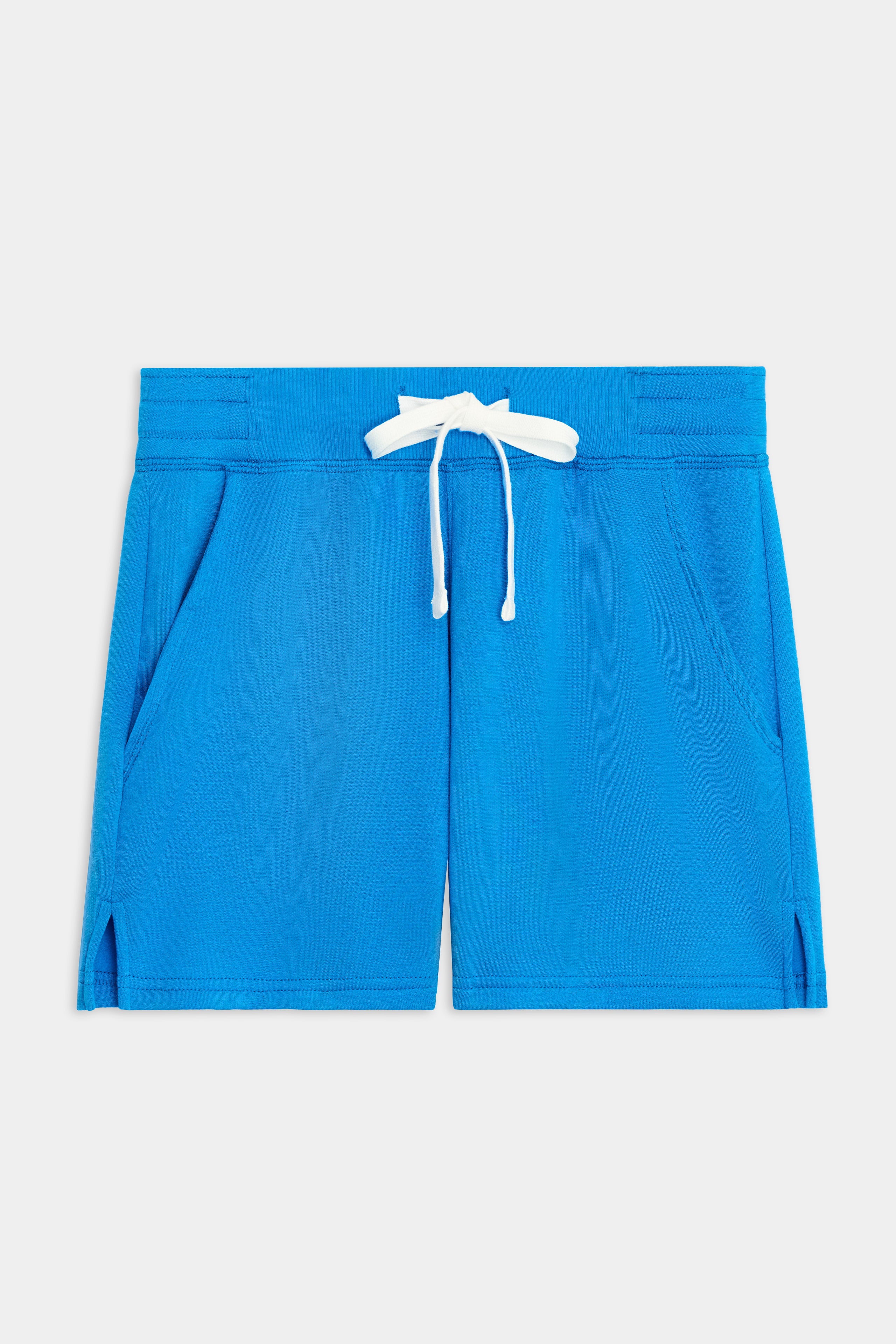 The SPLITS59 Reena Sweatshort - Riviera features a bright blue hue, soft modal-spandex fabric, elastic waistband with white drawstring, two front pockets, and small side slits at the hem.