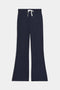 The SPLITS59 Blaire Rib Pant in navy blue features wide legs and a white drawstring waistband, shown flat on a white background.