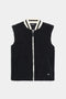 The SPLITS59 Aster Sherpa Vest in black features a white zip closure, two front pockets, and a white-striped collar, shown against a plain background.