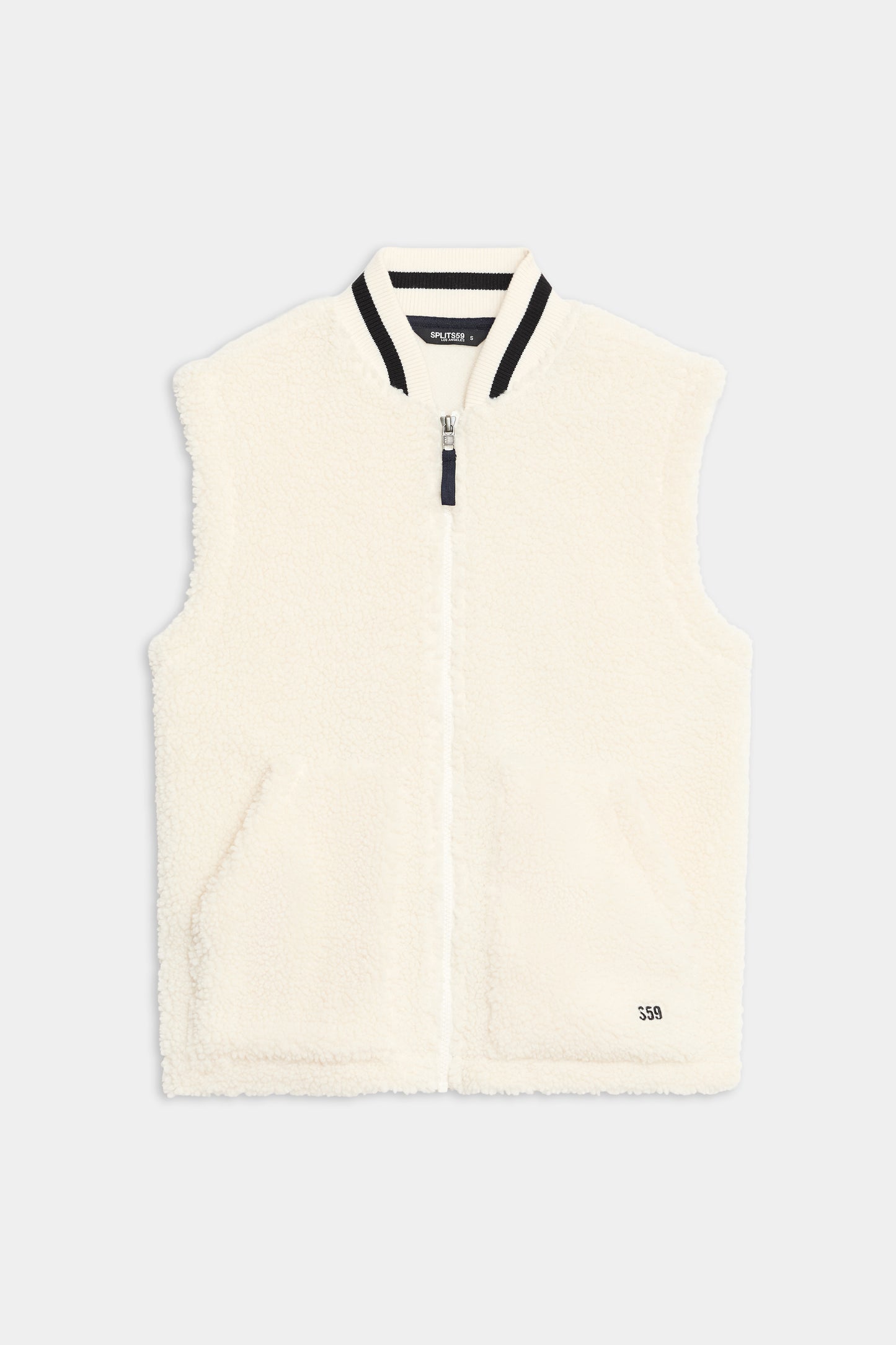 The SPLITS59 Aster Sherpa Vest is a sleeveless white fleece vest with a front zipper, ribbed collar, two front pockets, and "550" text near the hem.