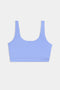 A light blue sports bra with wide shoulder straps and a scoop neckline, displayed on a plain white background.