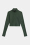 The SPLITS59 Stevie Active Rib Half Zip in Heather Military is a long-sleeve, dark green cropped athletic top with a mock neck and front half-zip, shown laid flat on a white background.