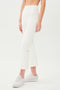 A woman wearing SPLITS59's Raquel High Waist Crop - White pant and white sneakers.