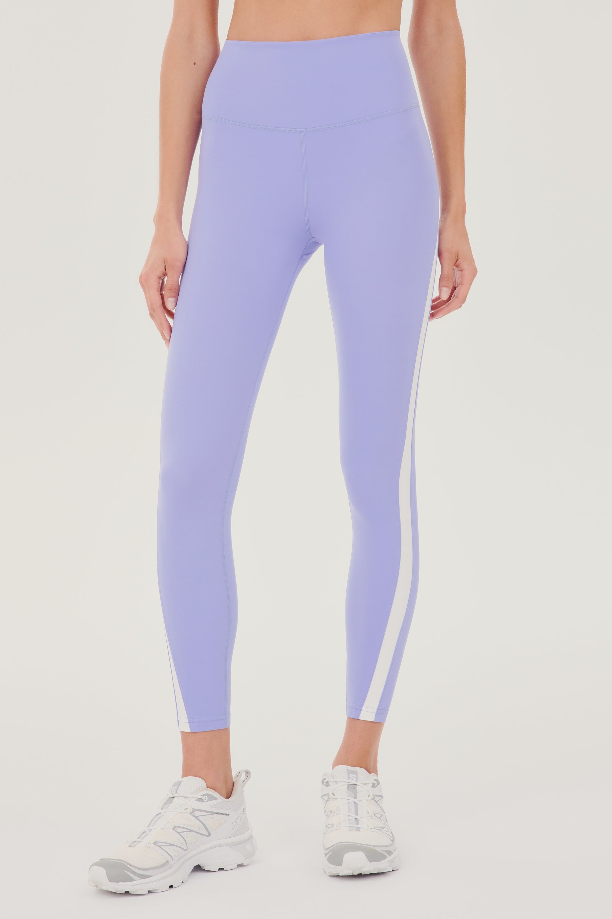 A woman's Miles High Waist Rigor 7/8 in Purple Haze/White by SPLITS59.