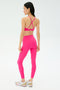 A woman faces away, wearing the SPLITS59 Sprint High Waist Rigor 7/8 leggings set in Berry with white sneakers, set against a plain light background.