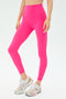 Wearing SPLITS59 Sprint High Waist Rigor 7/8 leggings in Berry and white athletic sneakers, a person stands against a plain light background.