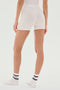 A person wearing SPLITS59 Theo Rib Short - White, a white top, and white socks stands facing away from the camera against a plain background.
