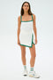 A person in a SPLITS59 Monah Rigor Tank in White/Arugula, paired with matching socks and white sneakers, stands ready for gym workouts against a plain background.