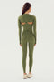 A person wearing SPLITS59's olive Airweight High Waist Legging and a long-sleeve, olive green athletic top crafted from a blend of nylon and spandex with cut-out back details, standing and facing away from the camera.