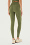 A person wearing SPLITS59 Airweight High Waist Leggings in Olive and beige sneakers is standing facing away from the camera.